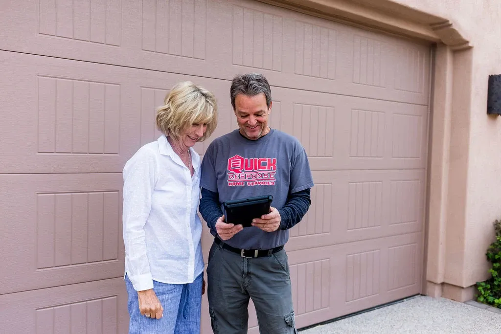 the owner of Quick Response Garae Door Services out on a job offering an estimate to a client in Phoenix, Arizona